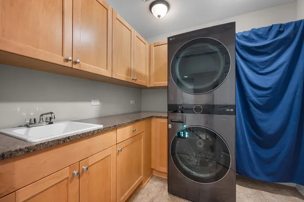a utility room with sink dryer and washer