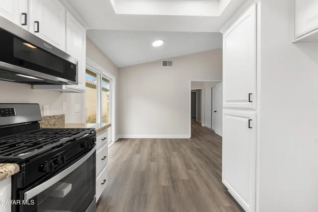 a kitchen with a stove and a refrigerator