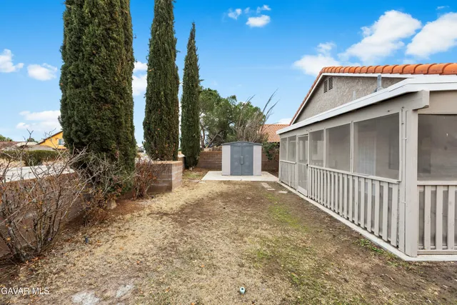 a backyard of a house with plants and trees