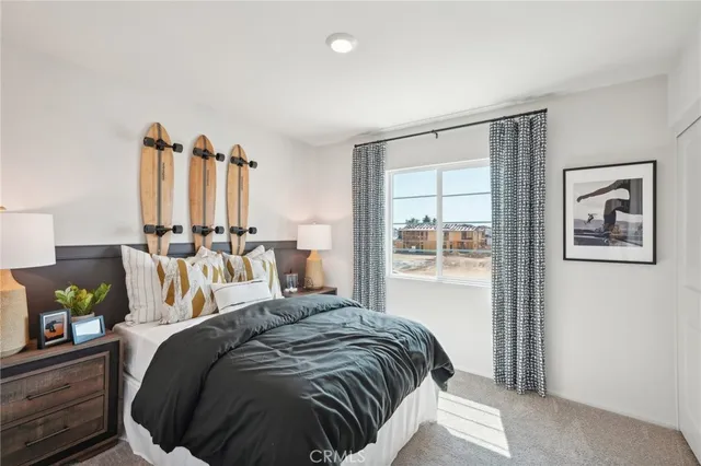 a bedroom with a large bed and a window