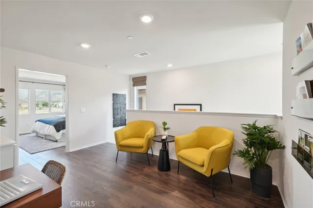 a living room with furniture and a potted plant