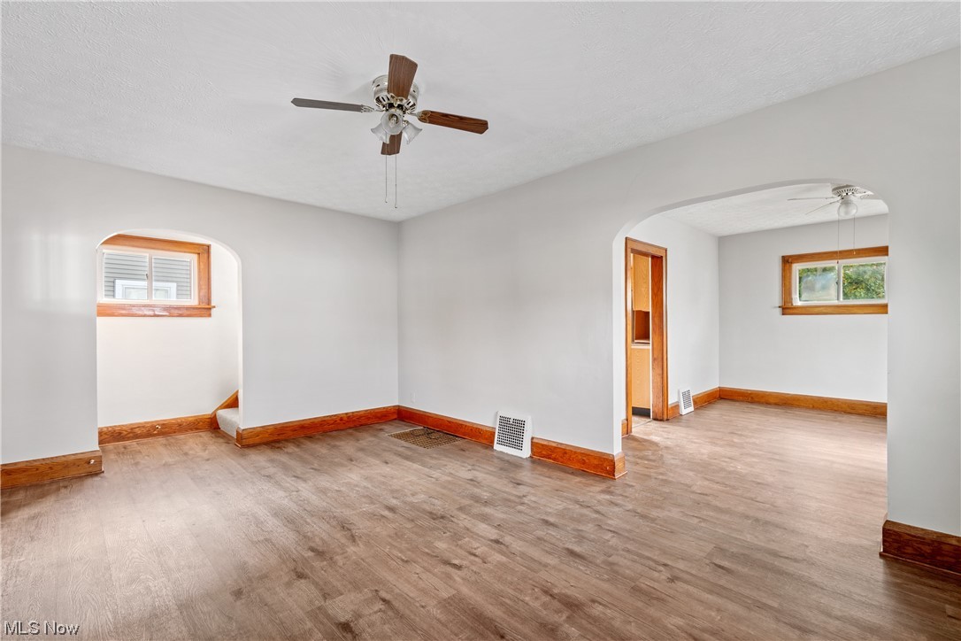 1529 Walnut Road Southwest Massillon, OH 44647 - Photo 5 of 27 Unfurnished room with wood-type flooring, a textured ceiling, and ceiling fan