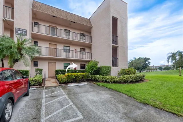 a front view of a residential apartment building with a yard