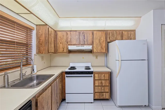 a kitchen with a sink and a refrigerator