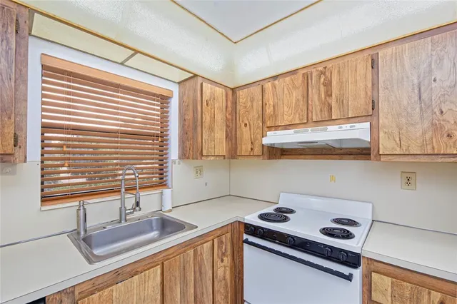 a kitchen with stainless steel appliances granite countertop a sink and a cabinets