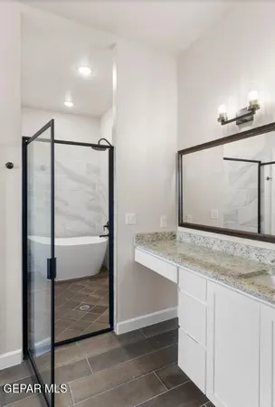 a bathroom with a granite countertop sink and a mirror