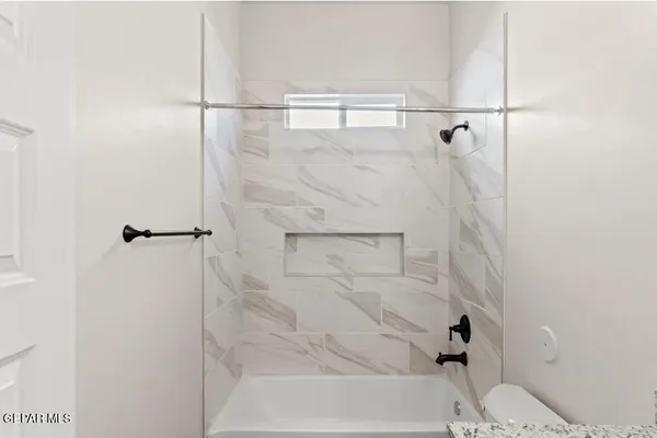 a bathroom with a bathtub and shower