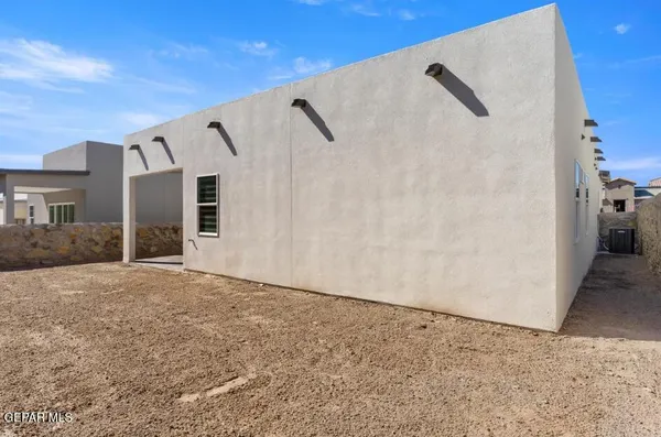a view of a white house with a street
