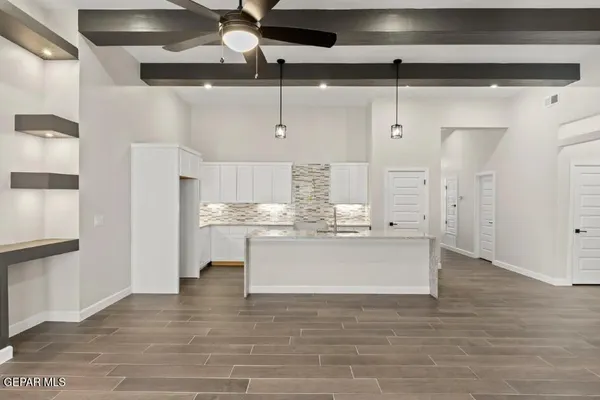 a kitchen with stainless steel appliances kitchen island granite countertop a refrigerator and a stove