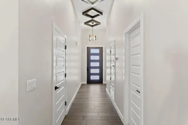 a view of a hallway with wooden floor and closet