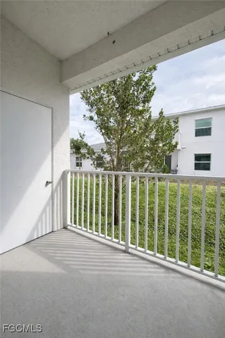an empty room with sliding glass door and shower