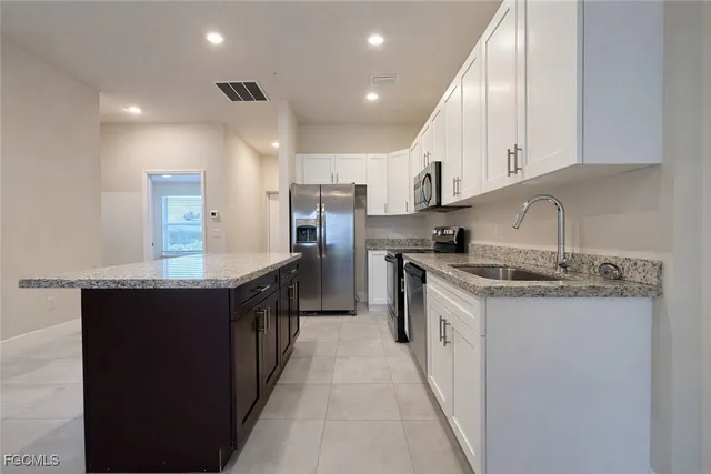 a kitchen with stainless steel appliances granite countertop a sink and cabinets