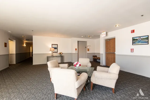 a living room with furniture and kitchen view