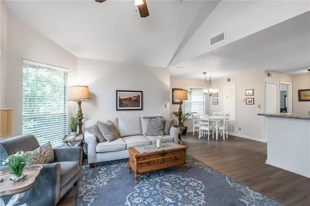 a living room with furniture potted plant and a window