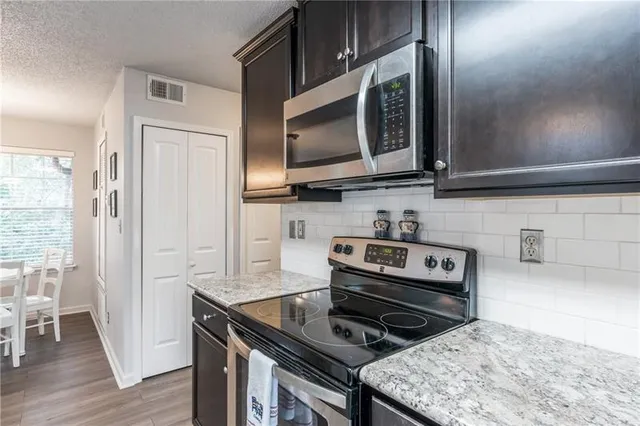 a kitchen with a stove and a microwave