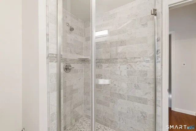 a bathroom with a glass shower door