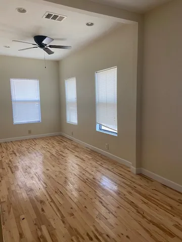 a spacious bathroom with a granite countertop sink and a mirror