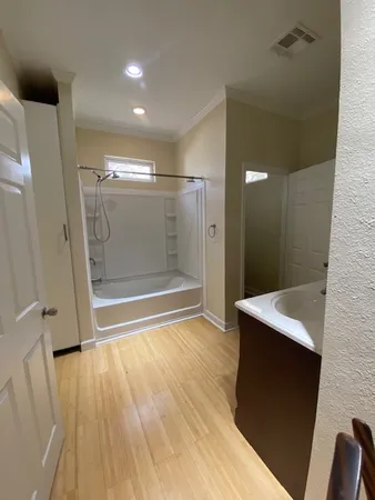 a bathroom with a sink a toilet a mirror and shower