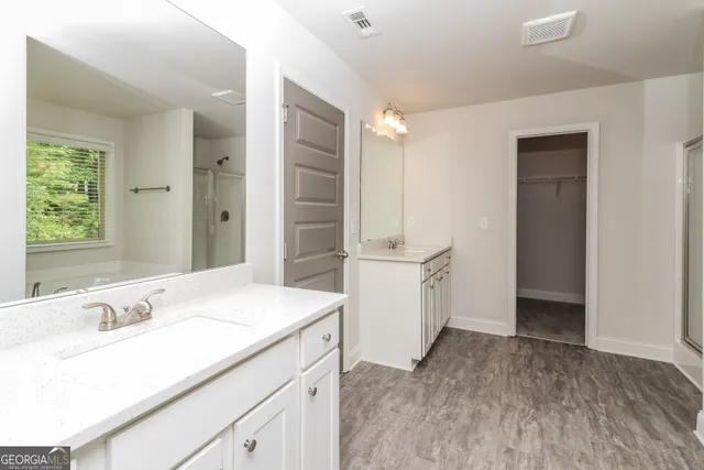 a bathroom with a sink double vanity and a mirror