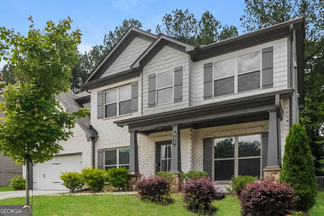 a front view of a house with garden