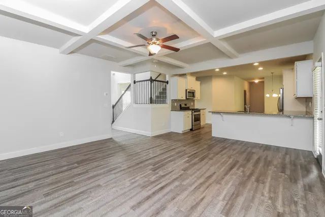 a view of a kitchen with a dishwasher and wooden floor