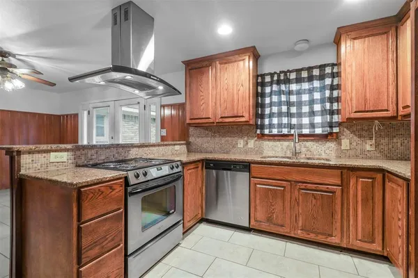a kitchen with a stove sink and cabinets