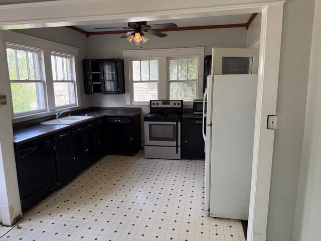 a kitchen with a refrigerator and a sink