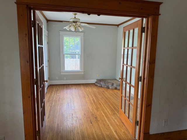 a view of a room with wooden floor and windows