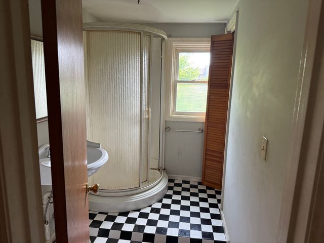 a bathroom with a toilet and a shower