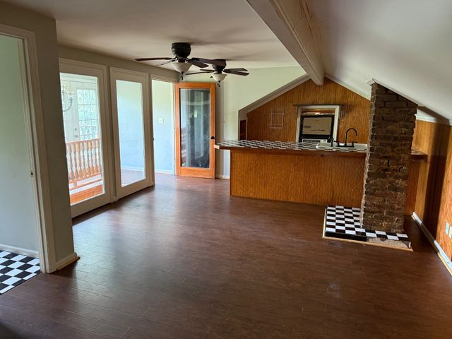 a view of an empty room and wooden floor