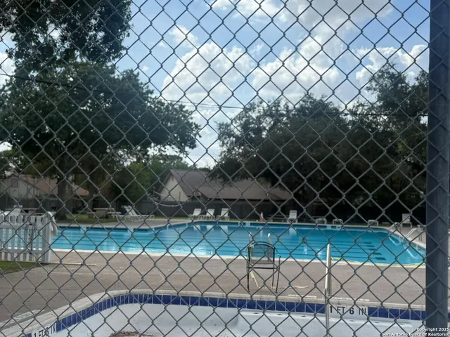 a view of a house with swimming pool and a yard