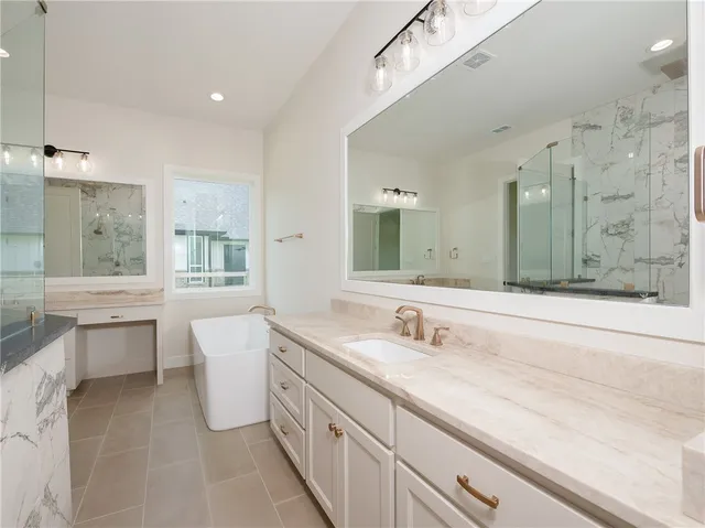 a spacious bathroom with a double vanity sink mirror and double