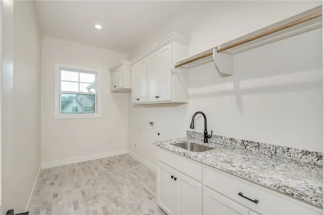 a kitchen with a sink cabinets and a window