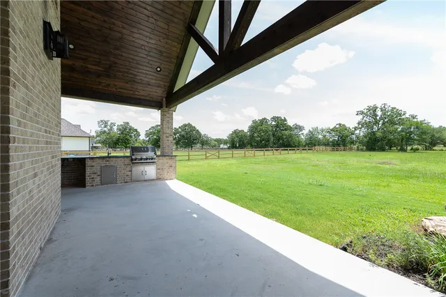 a view of a outdoor kitchen with a sink
