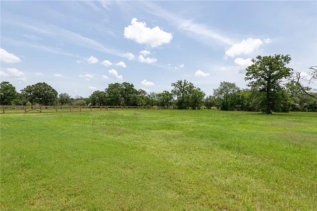 a view of a big yard with a garden