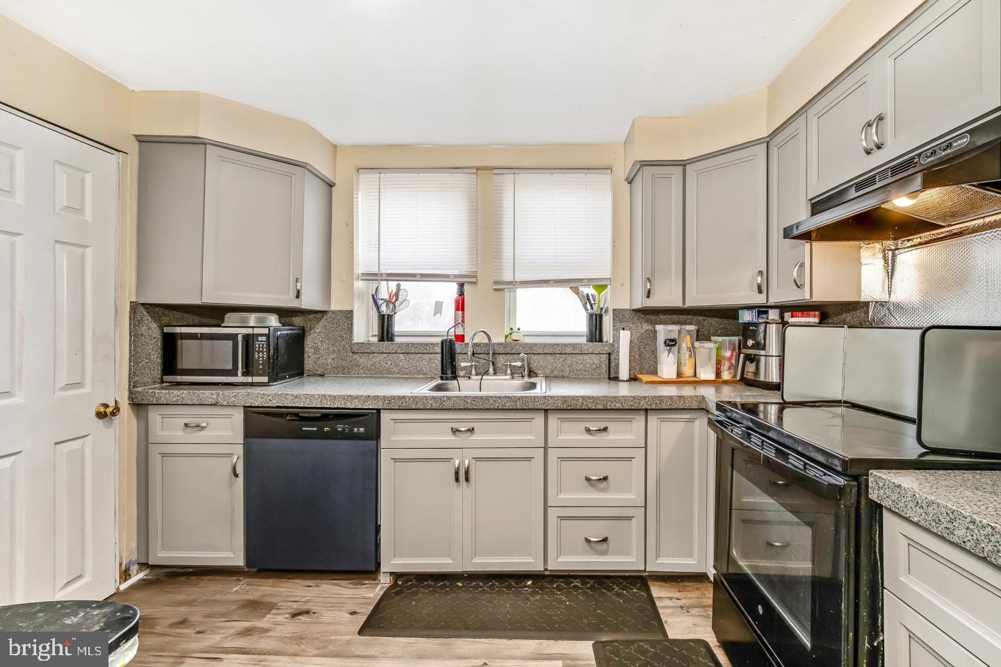 6243 Carpenter Street Philadelphia, PA 19143 - Photo 17 of 55 a kitchen with a sink stove and cabinets