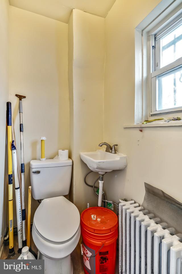 6243 Carpenter Street Philadelphia, PA 19143 - Photo 20 of 55 a bathroom with a sink a toilet and a mirror