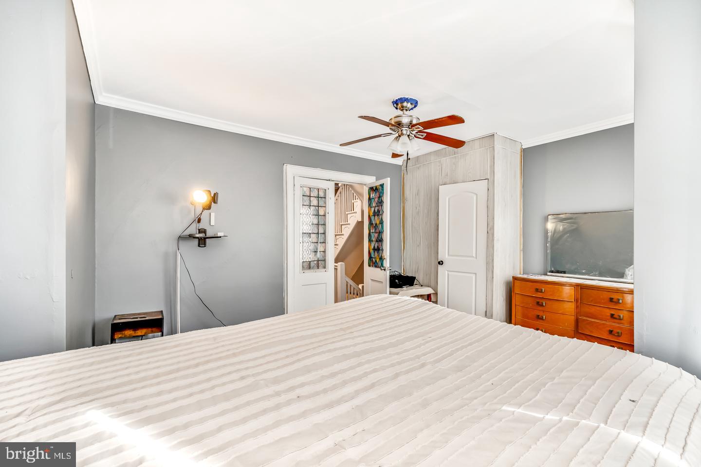 6243 Carpenter Street Philadelphia, PA 19143 - Photo 32 of 55 a bedroom with a bed and a chandelier