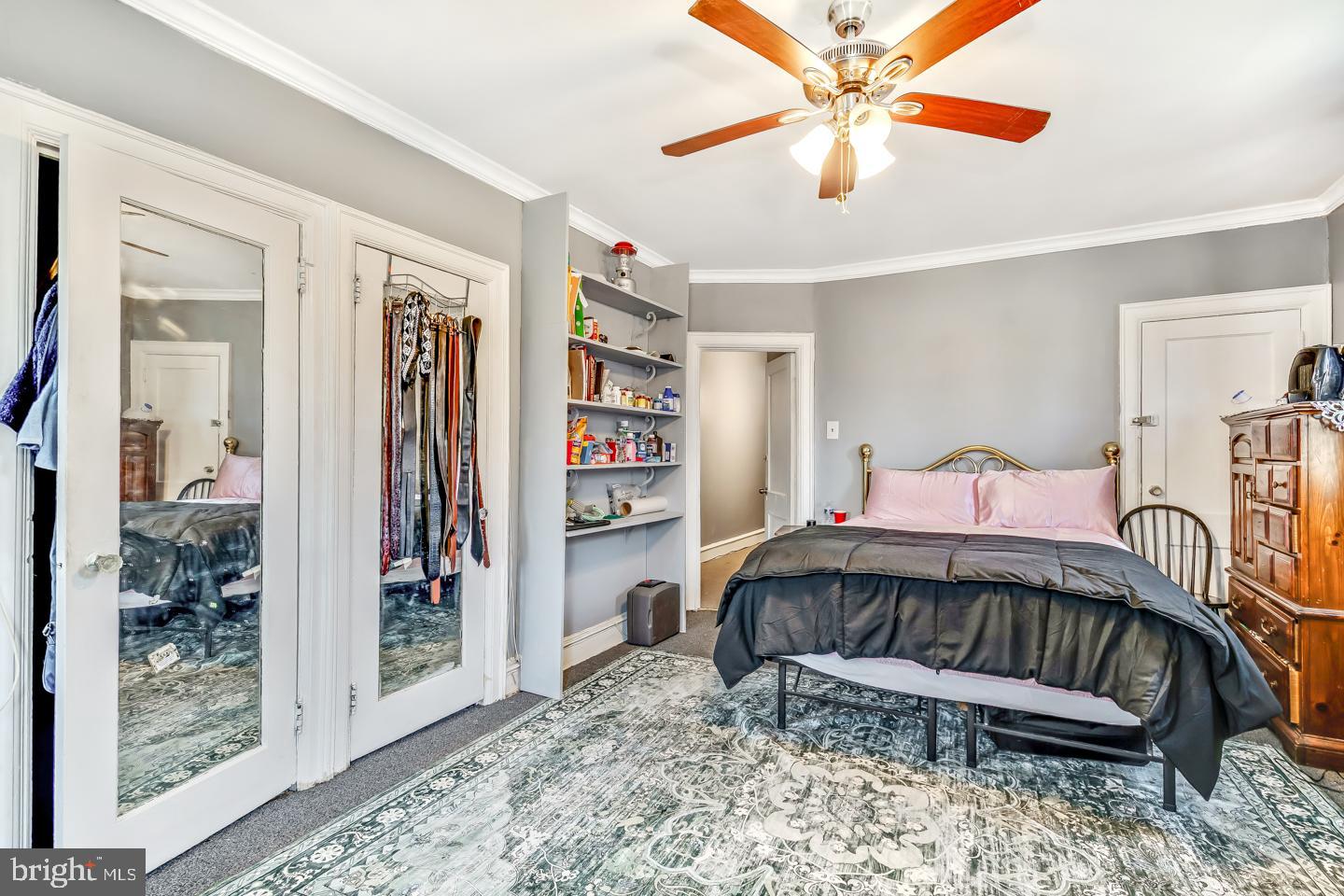 6243 Carpenter Street Philadelphia, PA 19143 - Photo 40 of 55 a bedroom with a bed and a chandelier