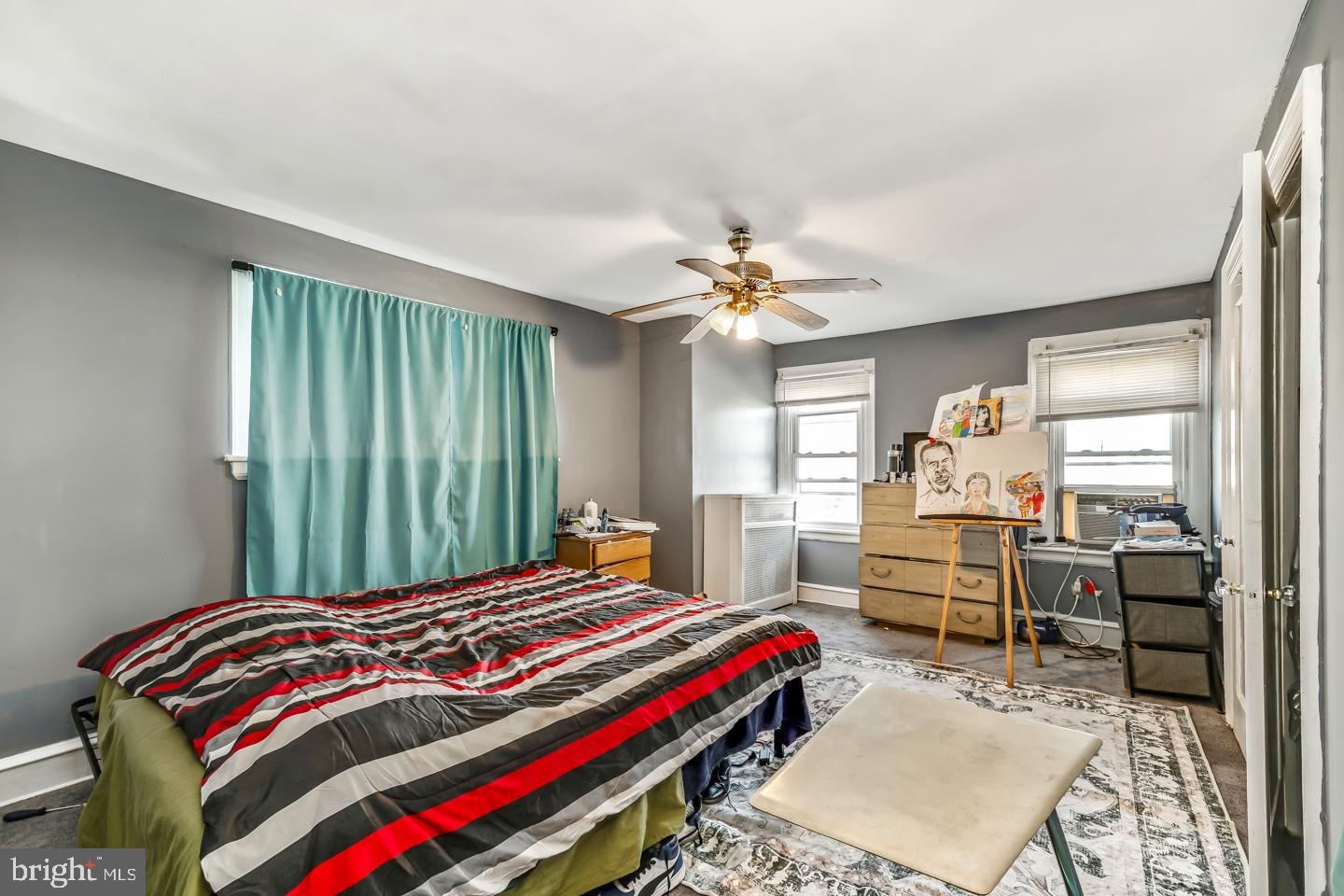 6243 Carpenter Street Philadelphia, PA 19143 - Photo 48 of 55 a bedroom with a bed and a chandelier