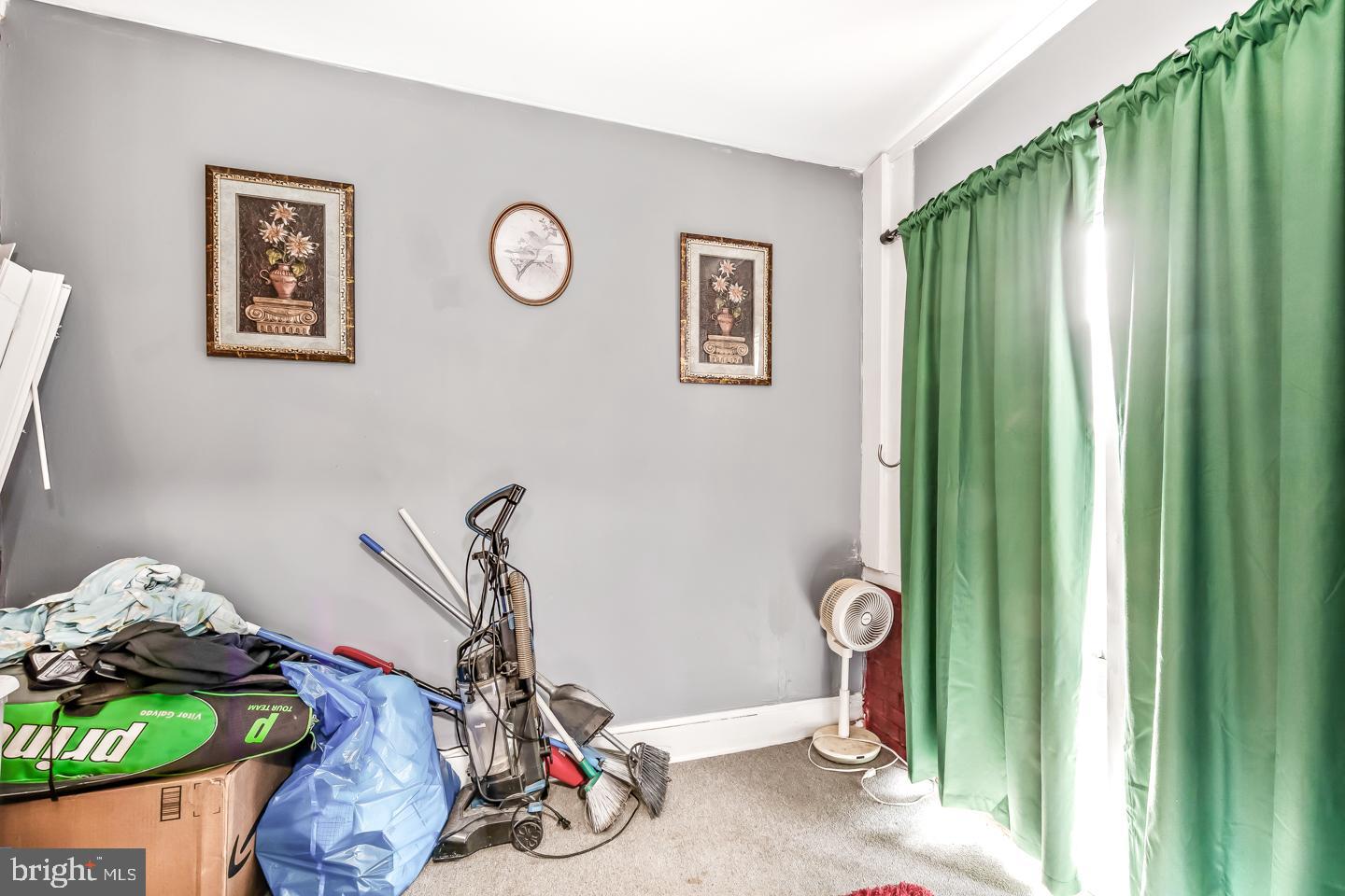 6243 Carpenter Street Philadelphia, PA 19143 - Photo 52 of 55 Cluttered corner with vibrant green curtains.