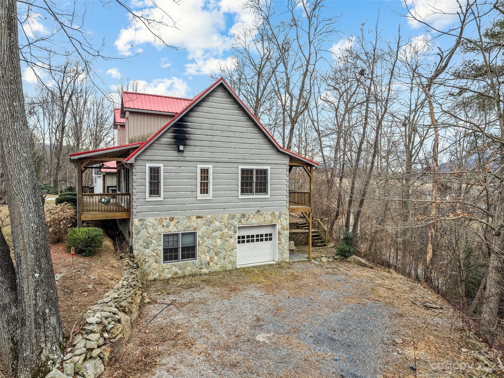 255 Loop Road Clyde, NC 28721 - Photo 5 of 38 a view of a house with a yard and garage