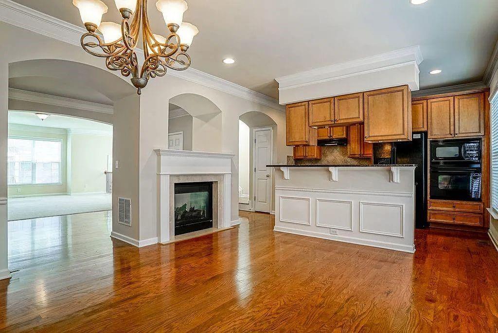 6120 Joybrook Road Duluth, GA 30097 - Photo 8 of 30 a kitchen with stainless steel appliances granite countertop a stove top oven cabinets a refrigerator and a fireplace