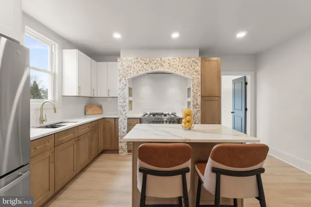 a kitchen with a table chairs a sink and a window