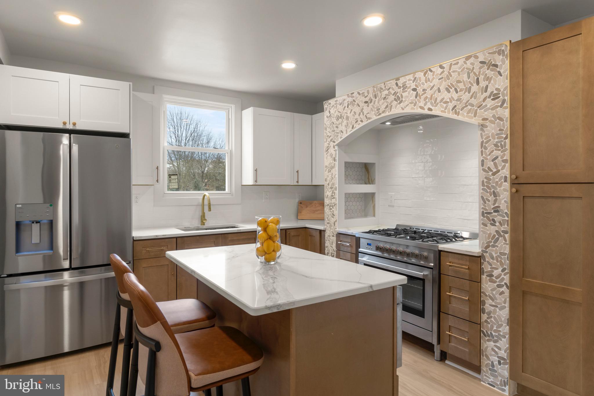 325 East 2nd Street Moorestown, NJ 08057 - Photo 9 of 39 a kitchen with stainless steel appliances granite countertop a stove a refrigerator a sink a dining table and chairs with wooden floor