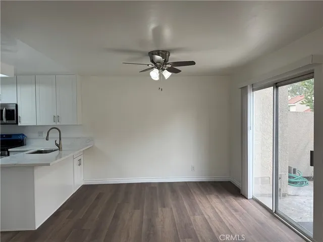 a kitchen with a sink cabinets and wooden floor