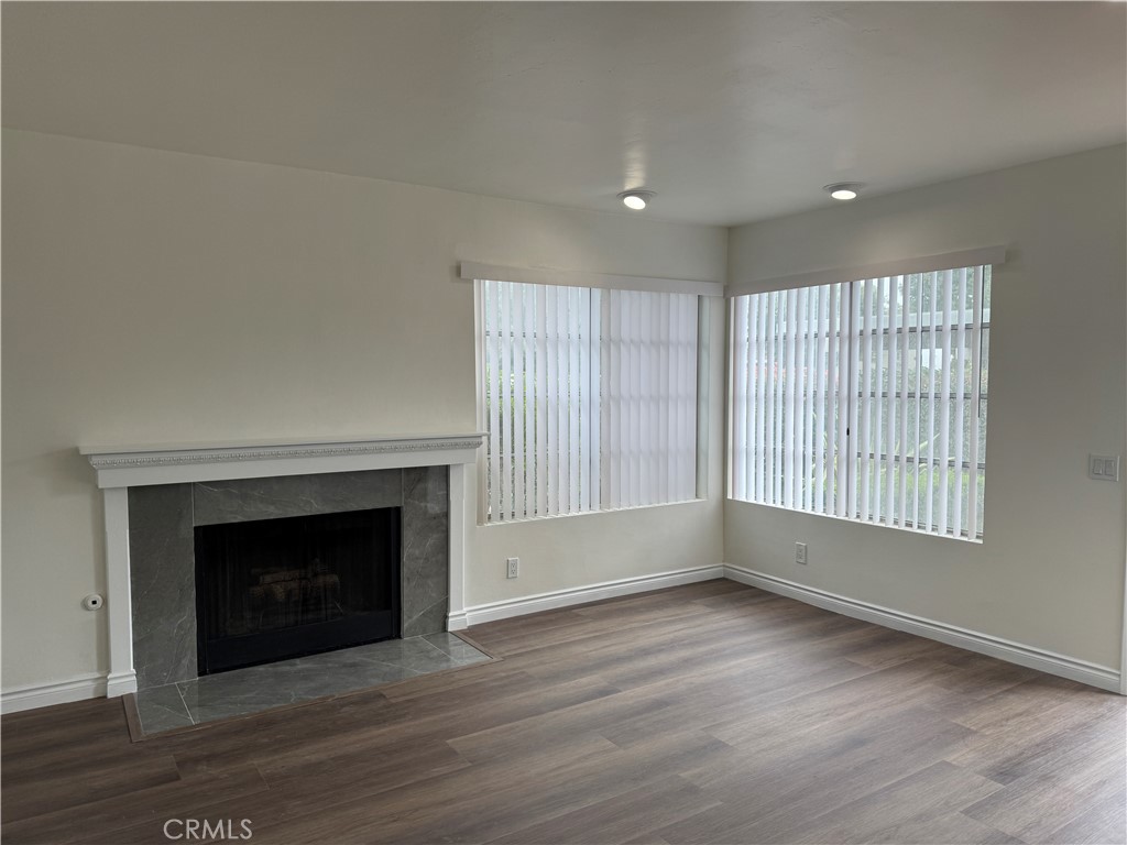 6 Columbia, Unit 2 Irvine, CA 92612 - Photo 12 of 25 an empty room with wooden floor fireplace and windows