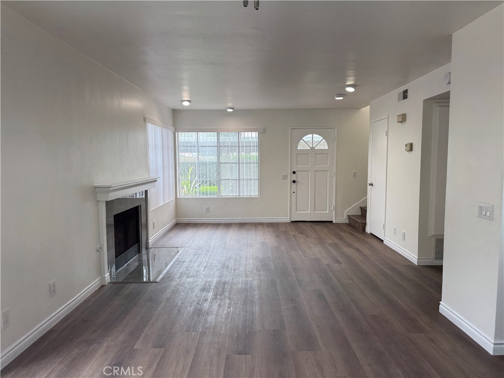 6 Columbia, Unit 2 Irvine, CA 92612 - Photo 13 of 25 an empty room with wooden floor and fireplace