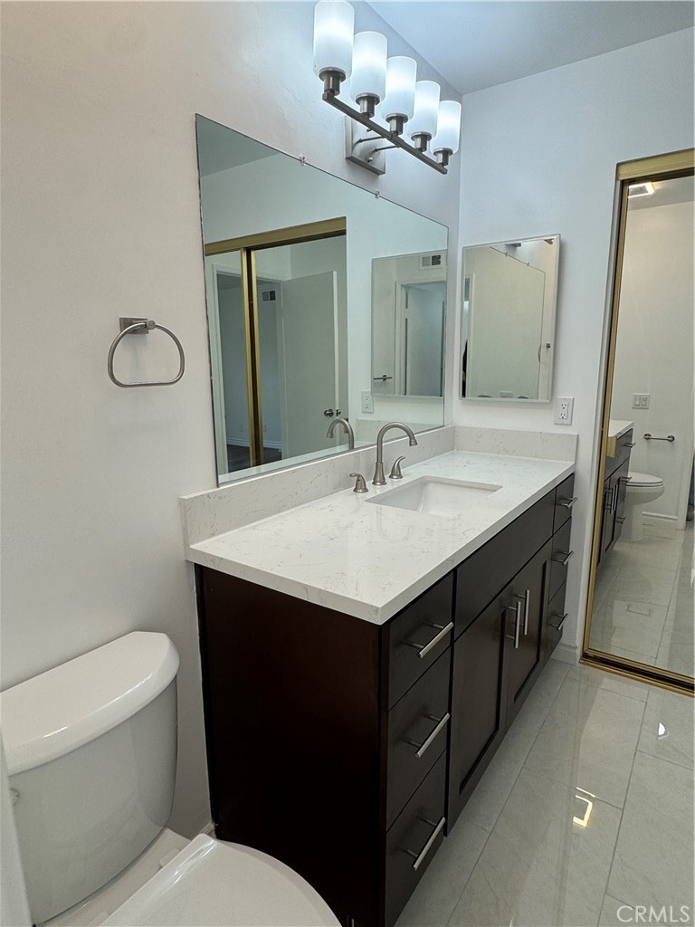 6 Columbia, Unit 2 Irvine, CA 92612 - Photo 17 of 25 a bathroom with a sink a toilet and mirror
