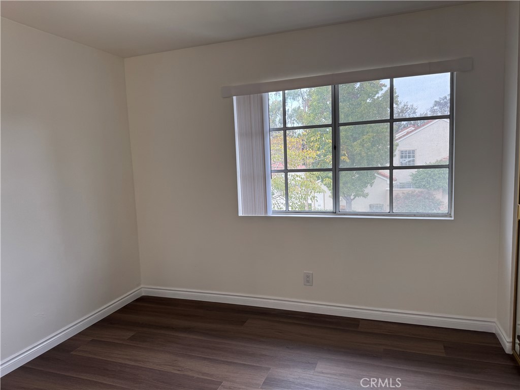 6 Columbia, Unit 2 Irvine, CA 92612 - Photo 21 of 25 an empty room with wooden floor and windows